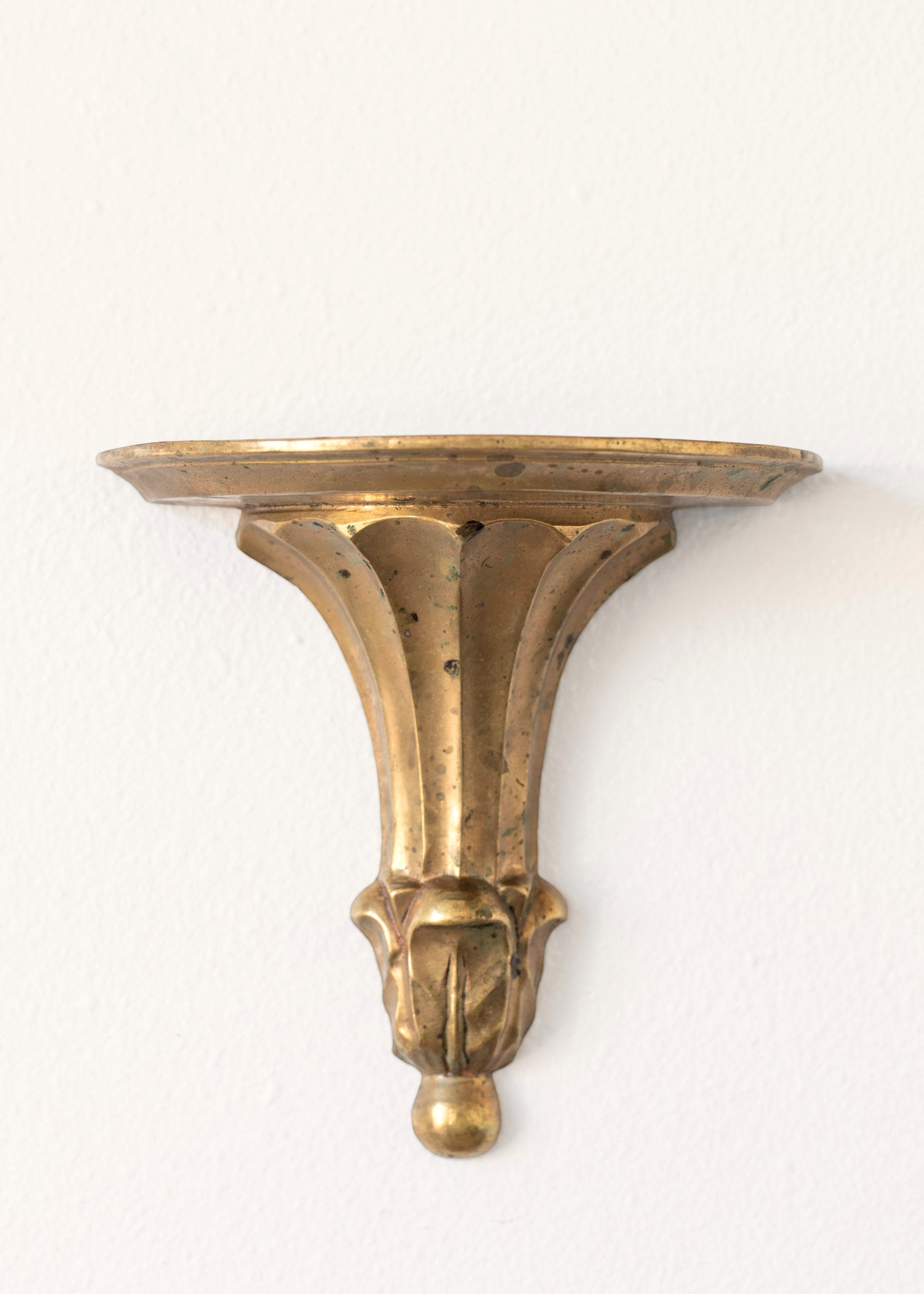 Hoppe Shoppe vintage brass wall shelf with ornate fluted corbel, leaf carvings, and a warm aged patina.
