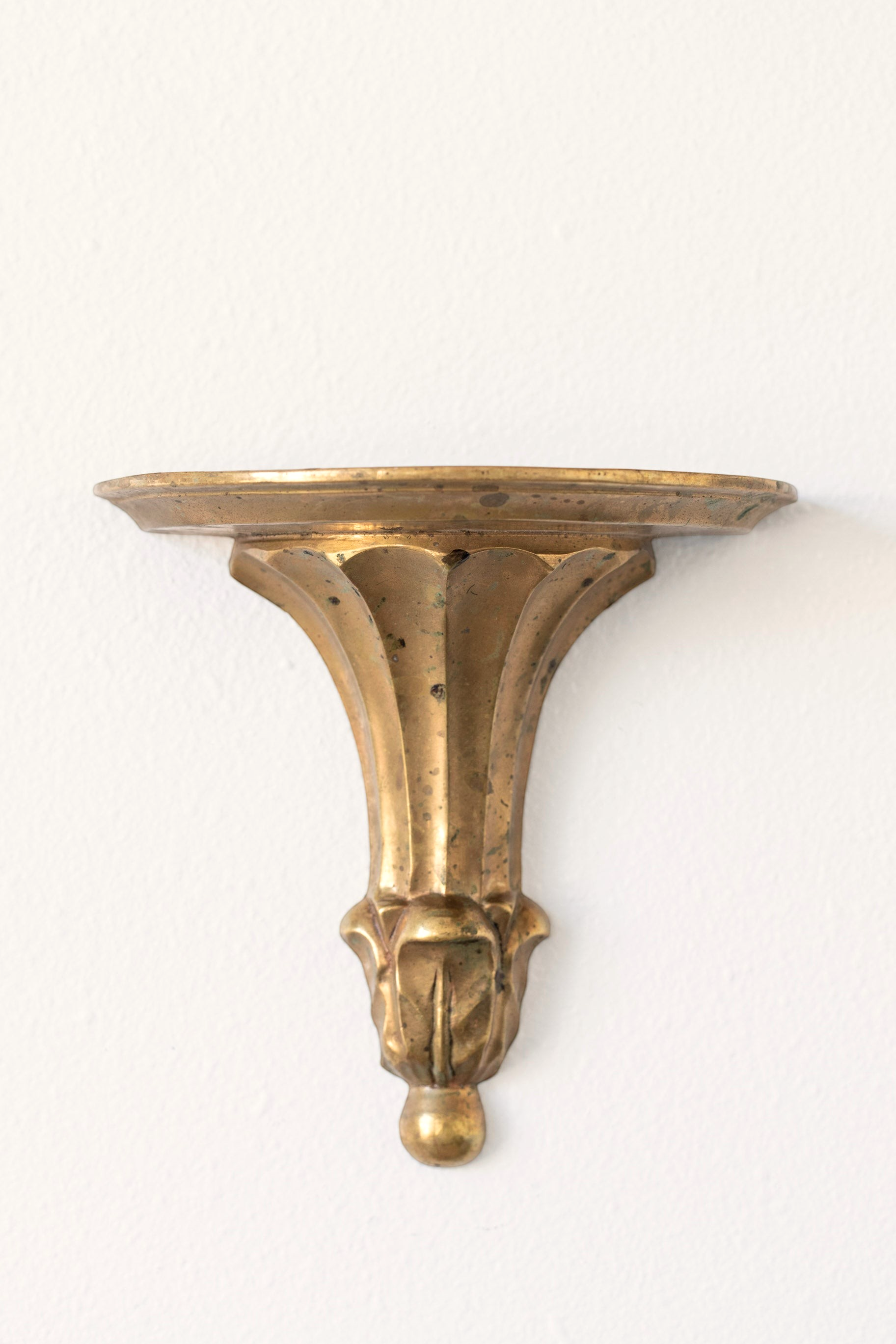 Hoppe Shoppe vintage brass wall shelf with ornate fluted corbel, leaf carvings, and a warm aged patina.