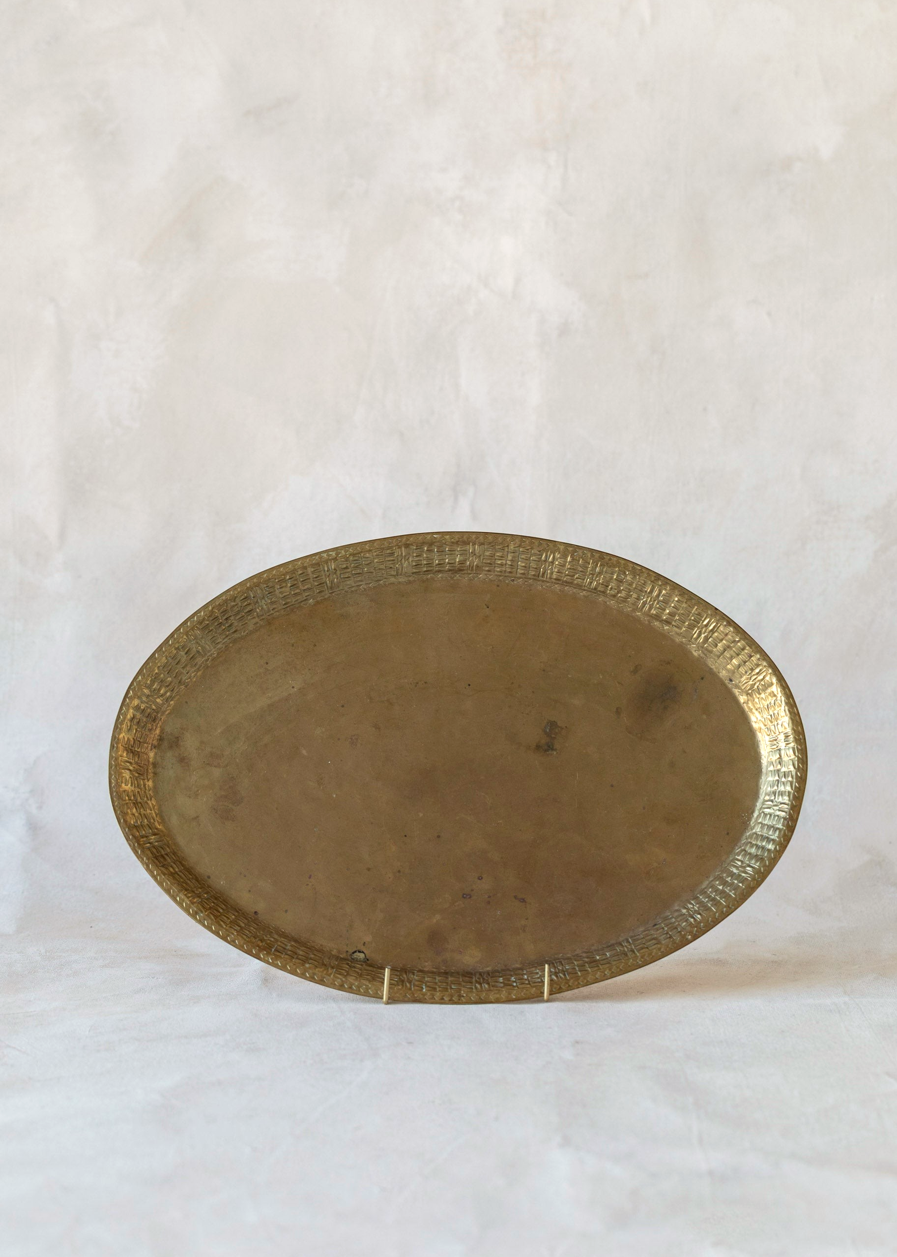 Hoppe Shoppe vintage large oval brass tray with a textured basketweave rim and warm aged patina finish.
